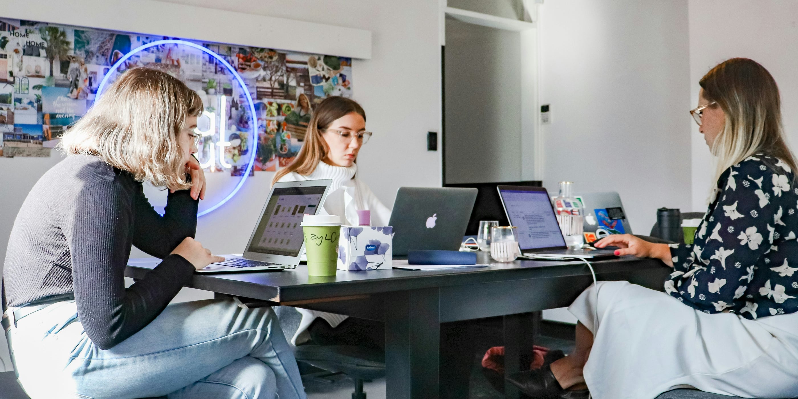 An illustration of a professional team in a modern office conducting a bid/no-bid analysis for government contracts. The scene features individuals reviewing documents, analyzing decision matrices on digital dashboards, and discussing strategic options. Visual elements such as checkmarks and crossmarks, financial charts, and government contract documents emphasize the importance of making informed bidding decisions.